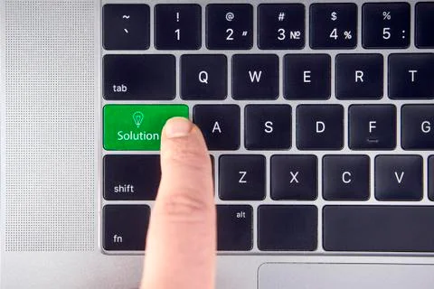 Closeup of green solution button on the keyboard Stock Photos