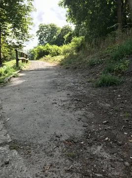 Closeup ground perspective of facing a pathway uphill with stone pieces caused b Stock Photos