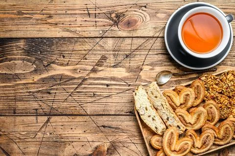 Closeup of a group of assorted cookies with cap of tea. wooden background. Top Stock Photos