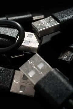 Closeup of a group of black USB-C to USB-A connection cables. Stock Photos