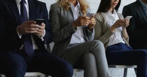 Closeup Of Group Of Business People Using Cell Smart Phones Touching Screen Stock Footage 77495956
