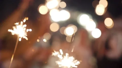 Closeup of the group of people holding a burning Sparkler into the evening. Soft Stock Footage 219721144