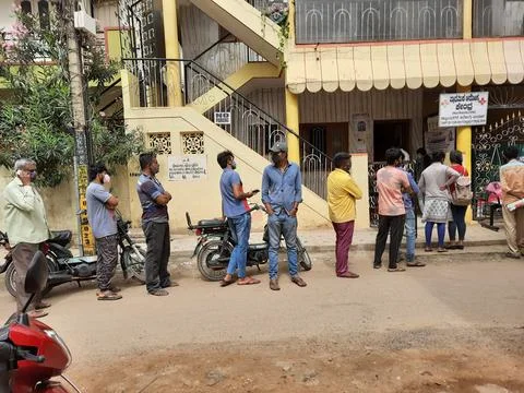 Closeup of group of peoples standing in a queue to take Covid 19 Vaccination  Stock Photos