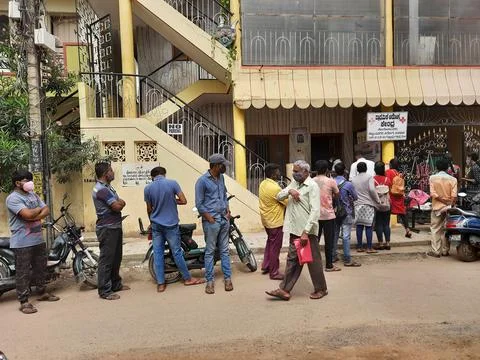 Closeup of group of peoples standing in a queue to take Covid 19 Vaccination  Stock Photos