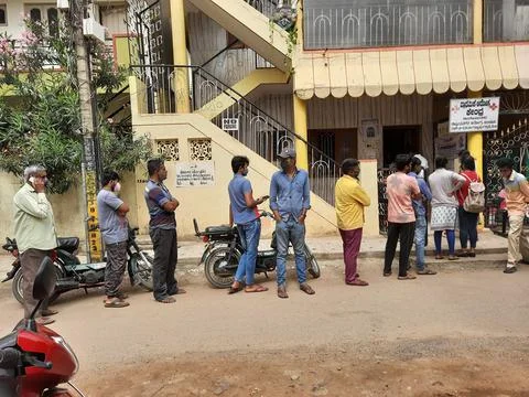 Closeup of group of peoples standing in a queue to take Covid 19 Vaccination  Stock Photos