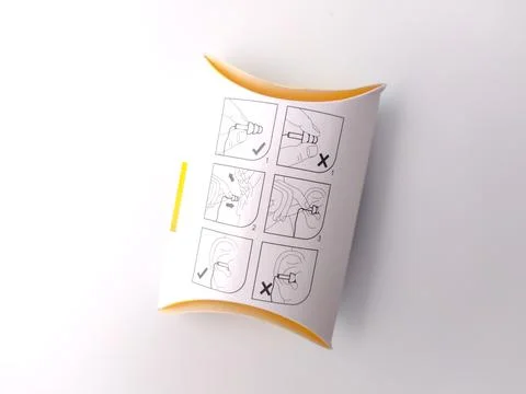 Closeup a guide on how to use ear plugs correctly is displayed on the back .. Stock Photos
