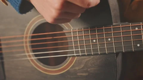 Closeup guitar strings and strumming hand focused technique fingerwork frets Stock Footage 332292045