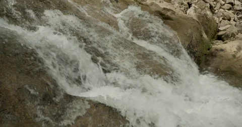 Closeup of a gurgling stream in slow motion Stock Footage 344147310