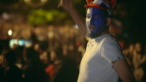 Closeup guy at camera scream crazy against background crowd to win football game Video stock 103826684