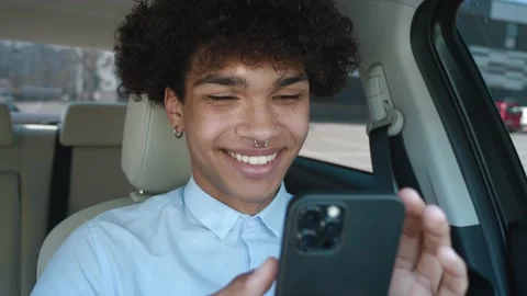 Closeup guy typing mobile phone in car. Afro american businessman chatting Stock Footage 154037087