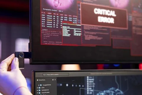 Closeup of hacker using USB to do data breach interrupted by critical error Stock Photos
