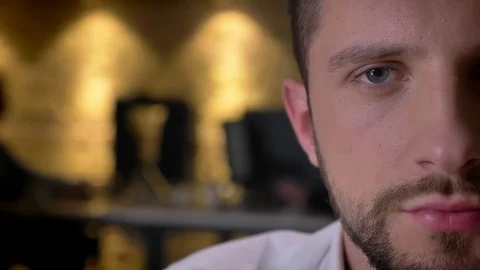 Closeup half-face portrait of young caucasian male face looking straight at Video stock 101315019
