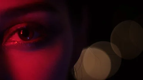 Closeup half-face shoot of pretty female eyes with seductive makeup with red Stock Footage 106938113