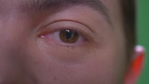 Closeup half face shoot of young attractive caucasian male with eyes looking at Stock Footage 108666314