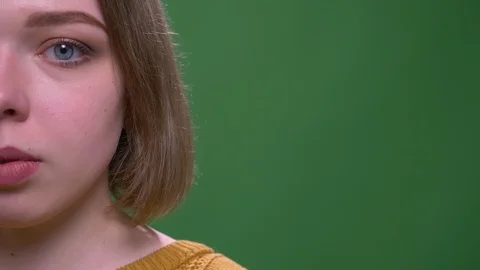 Closeup half face shoot of young attractive short haired female looking at Stock Footage 108689620