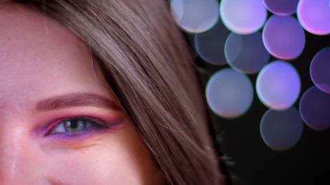Closeup half face shoot of young attractive caucasian female with pink beautiful Video stock 109200828