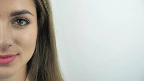 Closeup half-face shoot of young attractive caucasian female face with eyes look Stock Footage 135039478