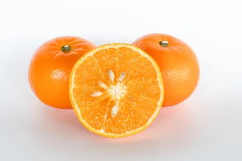 Closeup, Half orange and two oranges. White background Stock Photos