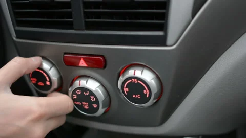 Closeup of hand adjusting the air conditioner button in the car. Man using Stock Footage 98419455