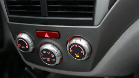 Closeup of hand adjusting the air conditioner button in the car. Man using Stock Footage 98419655