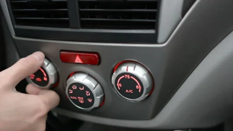 Closeup of hand adjusting the air conditioner button in the car. Man using Stock Footage 98419658