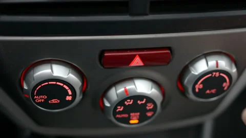 Closeup of hand adjusting the air conditioner button in the car. Man using Stock Footage 98419768