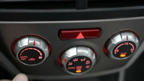 Closeup of hand adjusting the air conditioner button in the car. Man using Stock Footage 98419781