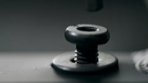 Closeup hand of anonymous man inserting screw in hole and turning it with Stock Footage 111948888