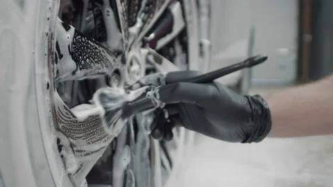 Closeup of a hand in black protective gloves using specialized car detailing Stock Footage 217397153