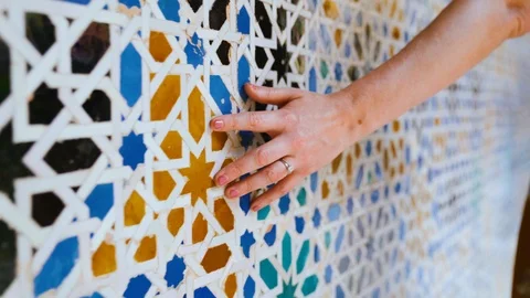 Closeup of a hand brushing along ornate colorful mosaic tile pattern on a wall Stock Footage 109299548