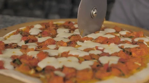 Closeup hand of chef baker cutting pizza at kitchen Stock Footage 107905835