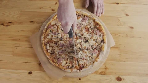 Closeup hand of chef baker in uniform cutting pizza at kitchen Stock Footage 72397100