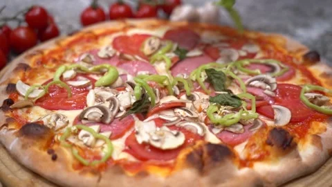 Closeup hand of chef baker in uniform blue apron cutting pizza at kitchen Video stock 135312888