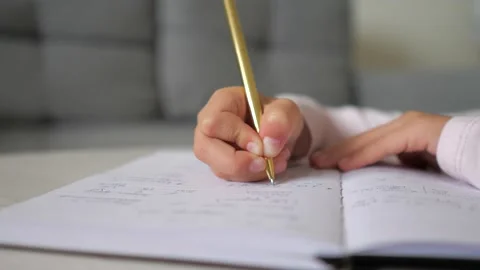 Closeup hand of child write in notebook. Little kid girl student learning doing Stock Footage 217428760
