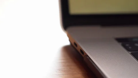 Closeup hand connecting data cable to port on computer laptop Stock Footage 127285007