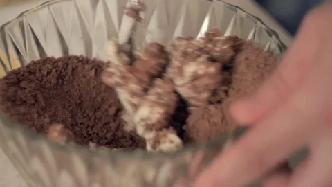 Closeup of the hand of cooking at home in the kitchen baking. Mixing dough in a Stock Footage 78730659
