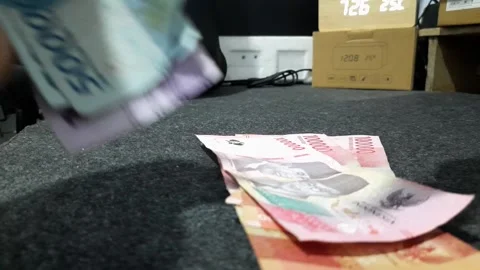 Closeup hand counting Indonesian Rupiah banknotes Stock Footage 330136744