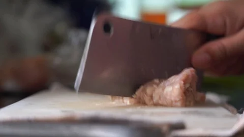 Closeup hand cutting pork preparing ingredient for cooking Video stock 130048459