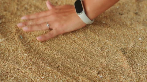 Closeup of hand drawing circles on beach. Relaxing seaside activity where hand Stock Footage 338286206