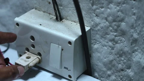 Closeup of a hand flipping a switch on a wall mounted electrical outlet Stock Footage 345188948