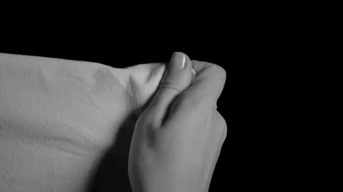 Closeup of a hand grabbing a sheet. Stock Footage 211047957