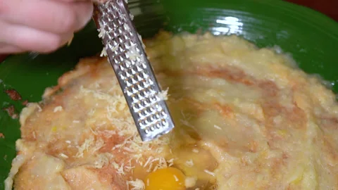 Closeup of hand grating garlic with  a small metal grater Stock Footage 247513810
