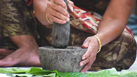 Closeup of hand grinding herbs in mortar and pestle Stock Footage 138190505