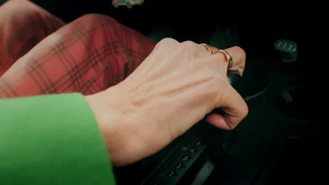 A CloseUp of a Hand Gripping the Gear Shift in a Beautiful Classic Car Interior Stock Footage 303719860
