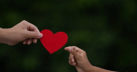 Closeup of Hand holding paper red heart shape. Male hand giving heart paper  Stock-Footage 201394280