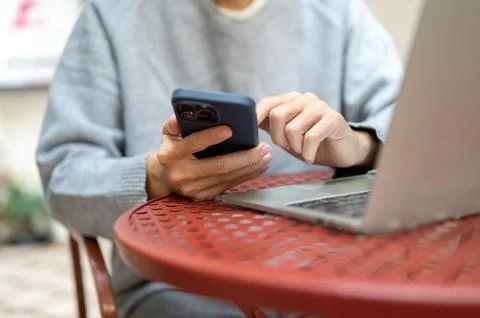 Closeup of hand holding using phone looking through social media watching v.. Stock Photos