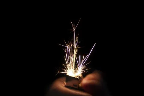 Closeup to hand igniting fire lighters with black background Stock Photos