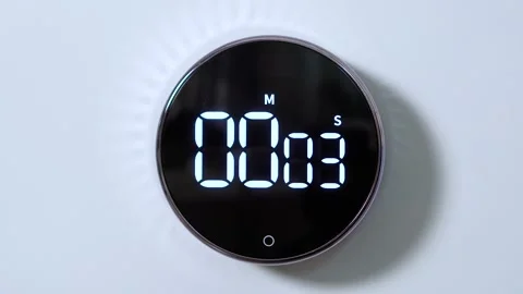 Closeup of hand includes round kitchen electronic stopwatch from 0 to 21 seconds Stock Footage 150875686