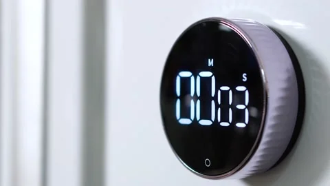 Closeup of hand includes round kitchen electronic stopwatch from 0 to 21 seconds Stock Footage 151010939