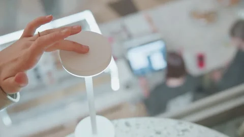 Closeup of hand interacting with touch sensitive white table lamp demonstrating Stock Footage 345065513